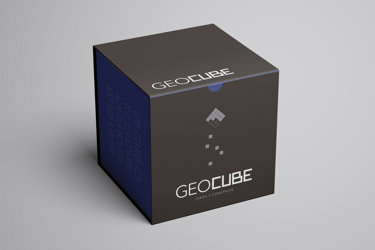 Packaging of a game called Geocube, cubic dark grey box with blue sides